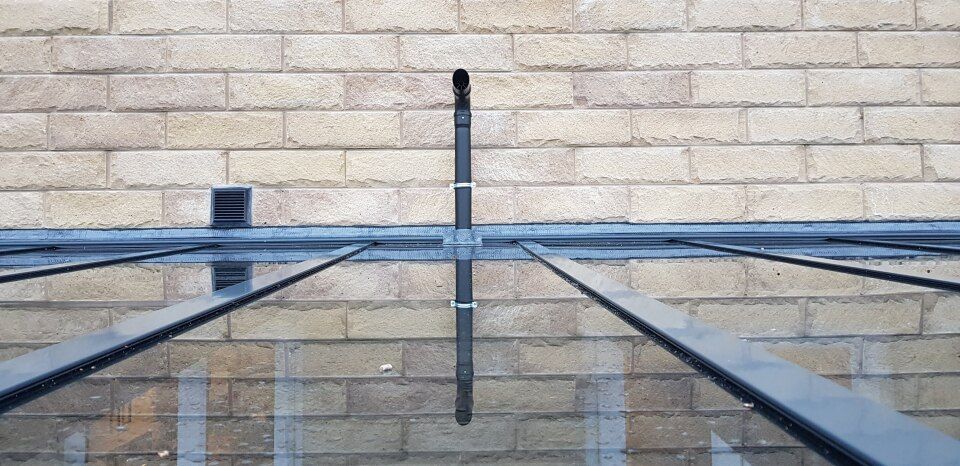 A brick wall with a canopy on top of it.