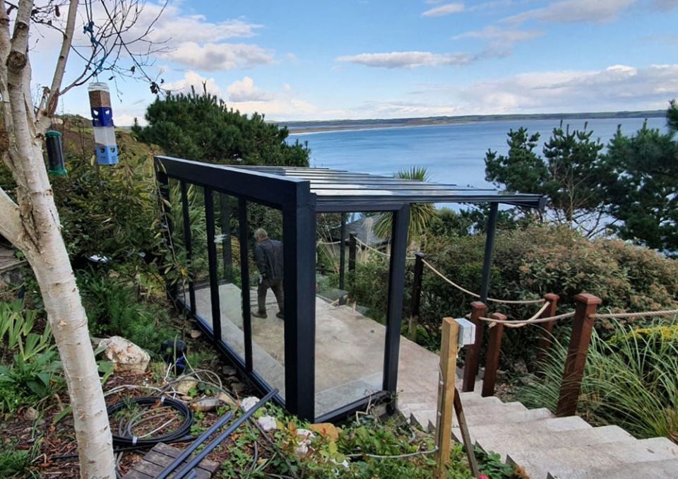 A staircase leading up to a building with a view of the ocean.