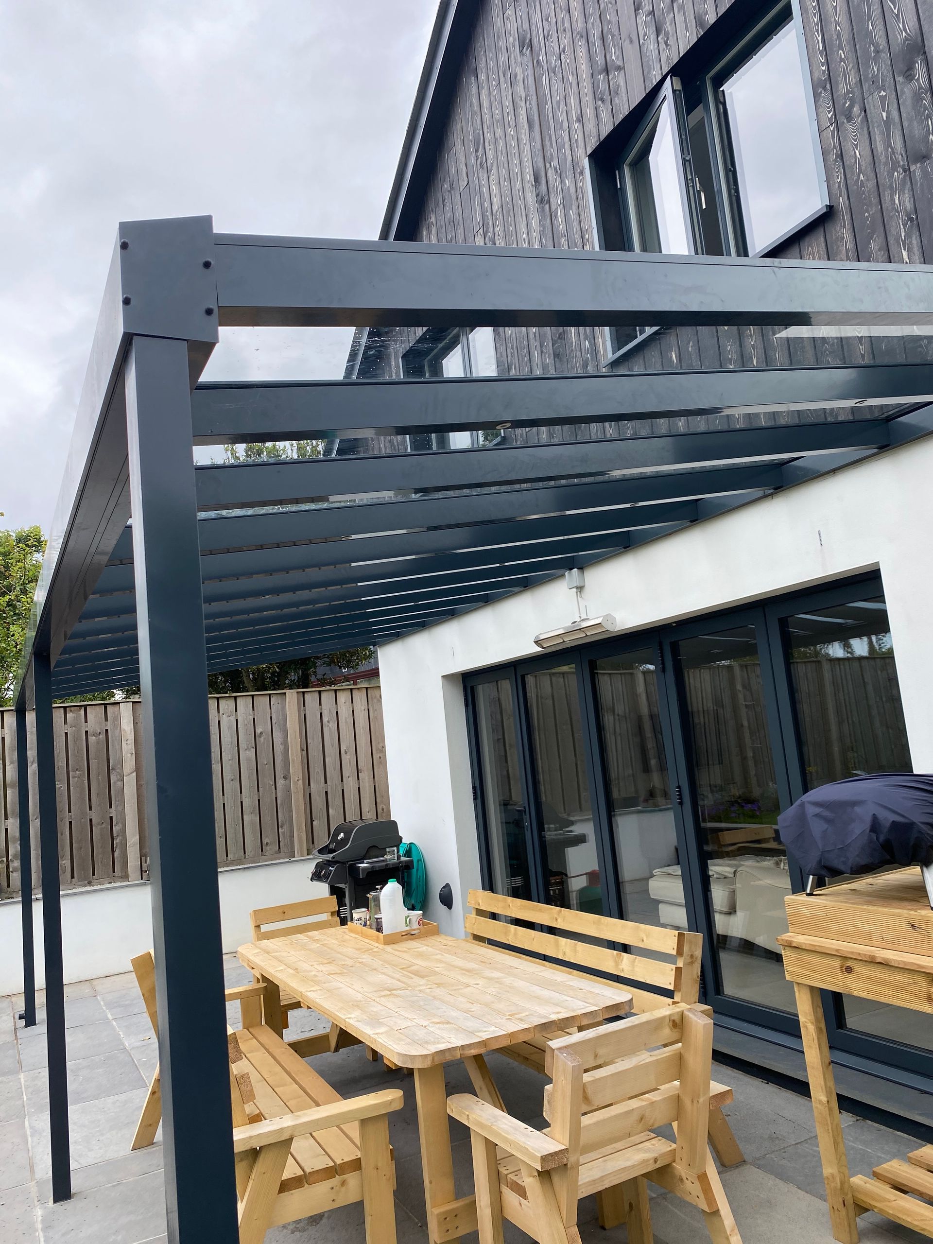 A patio with a table and chairs under a canopy