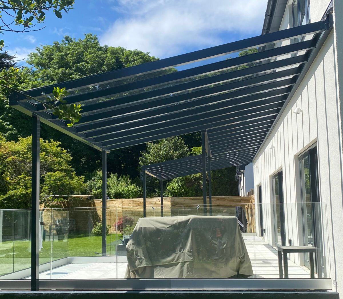A patio with a canopy over it and a table underneath it.
