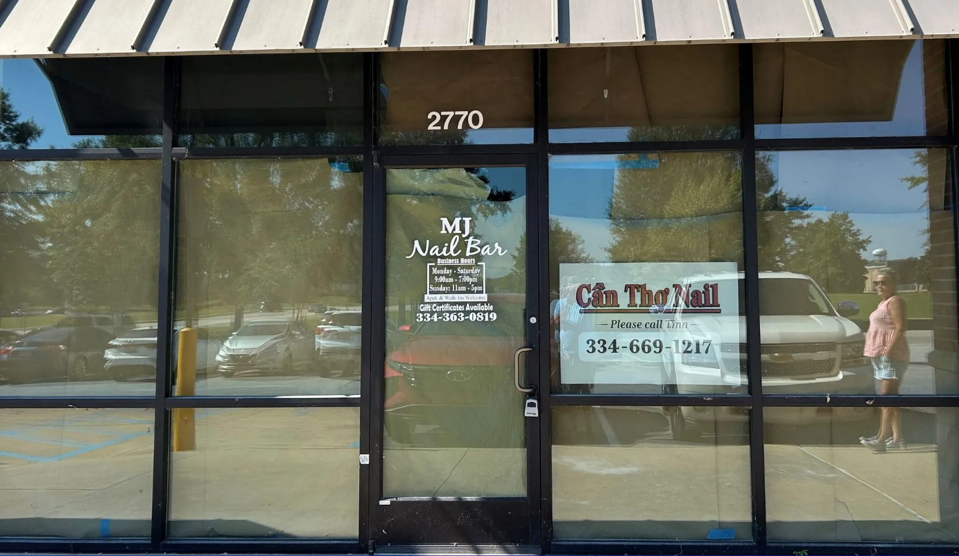 Glass-fronted storefront with door number 2710 and a sign for a tax office