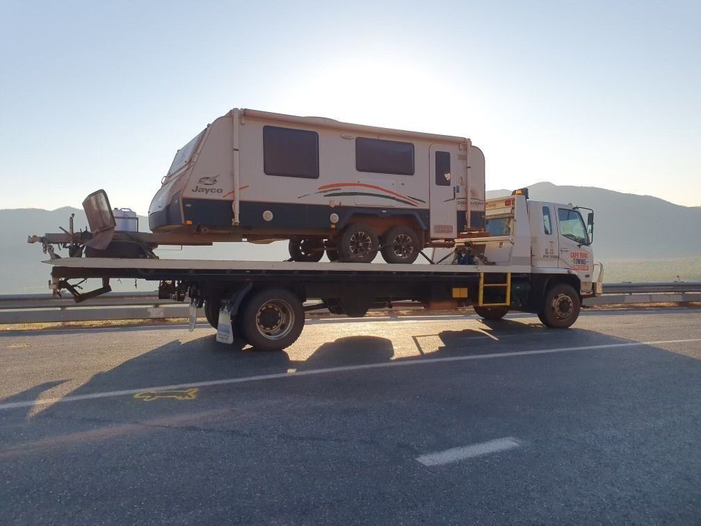 A Camper is Being Towed by a Tow Truck — Johnson River Towing In Mission Beach, QLD