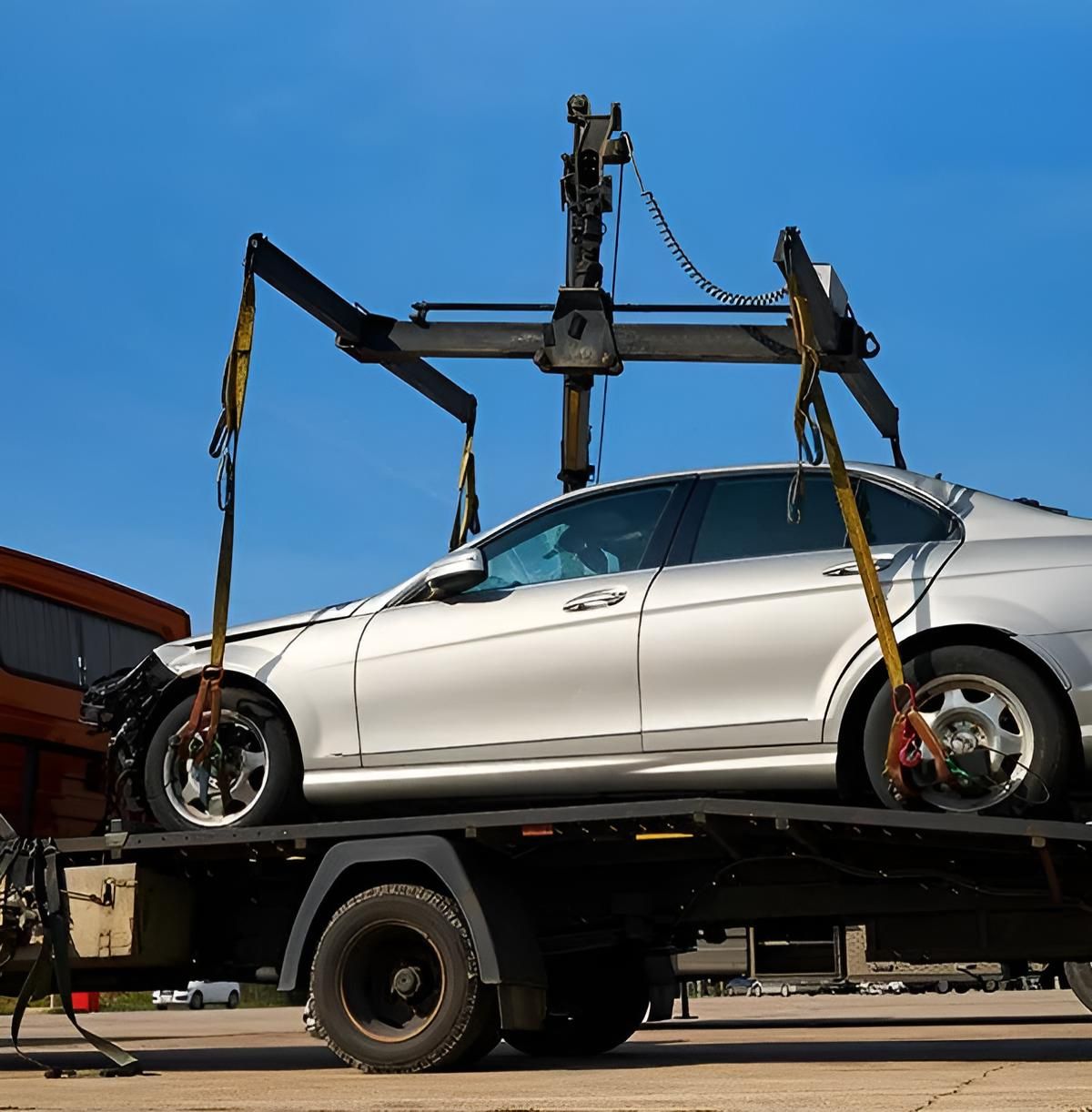A White Car is Sitting on Top of a Tow Truck — Johnson River Towing In Innisfail, QLD