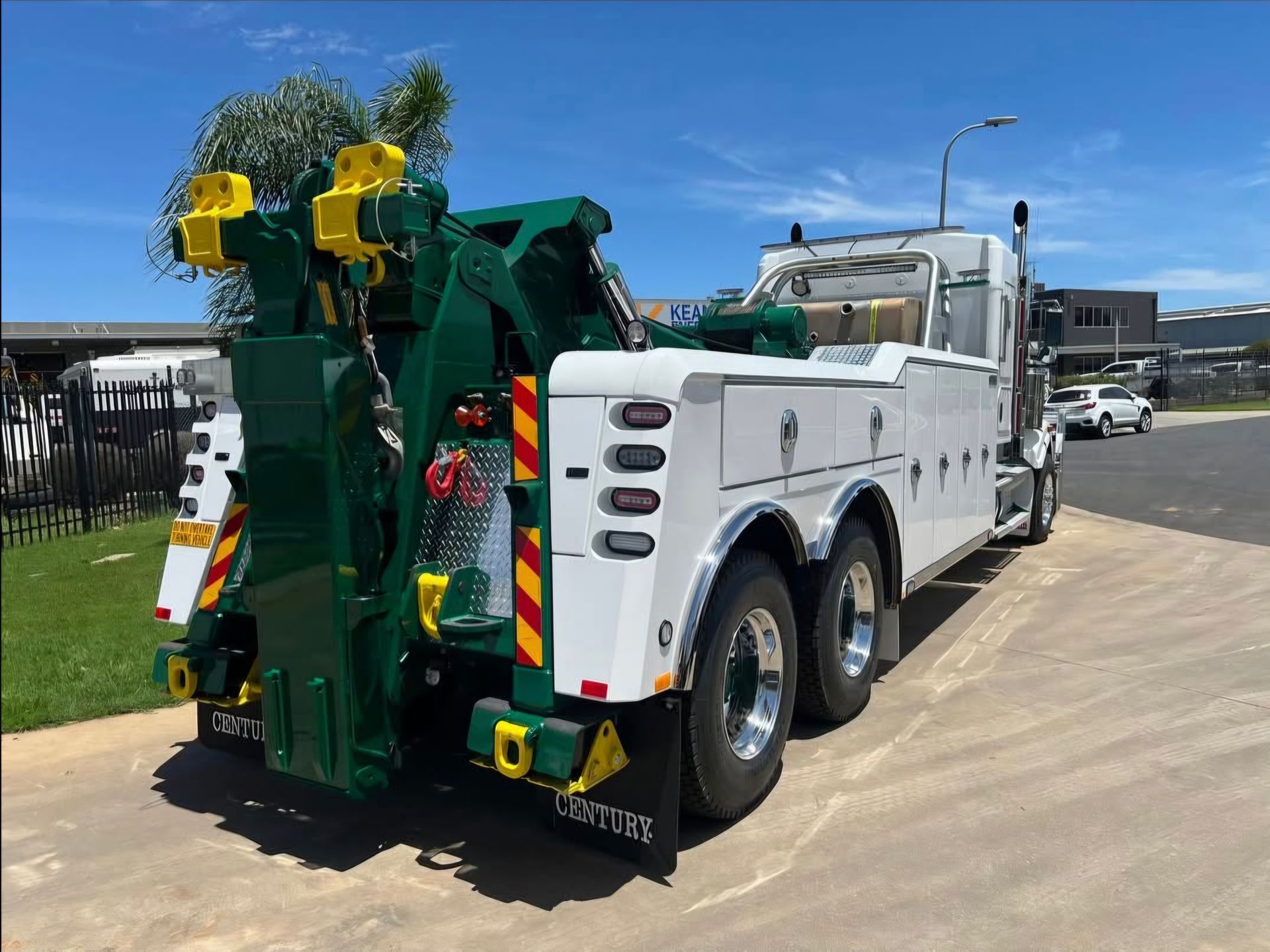 A White Car is Sitting on Top of a Tow Truck — Johnson River Towing In Innisfail, QLD