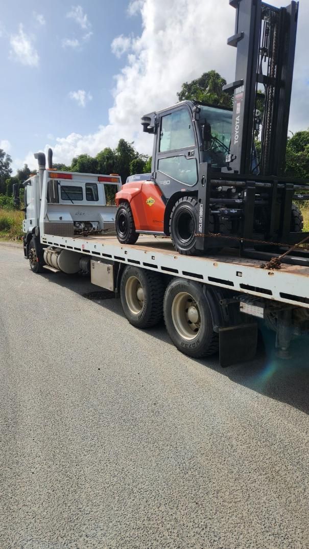 A Forklift is Sitting on Top of a Flatbed Truck — Johnson River Towing In Innisfail, QLD