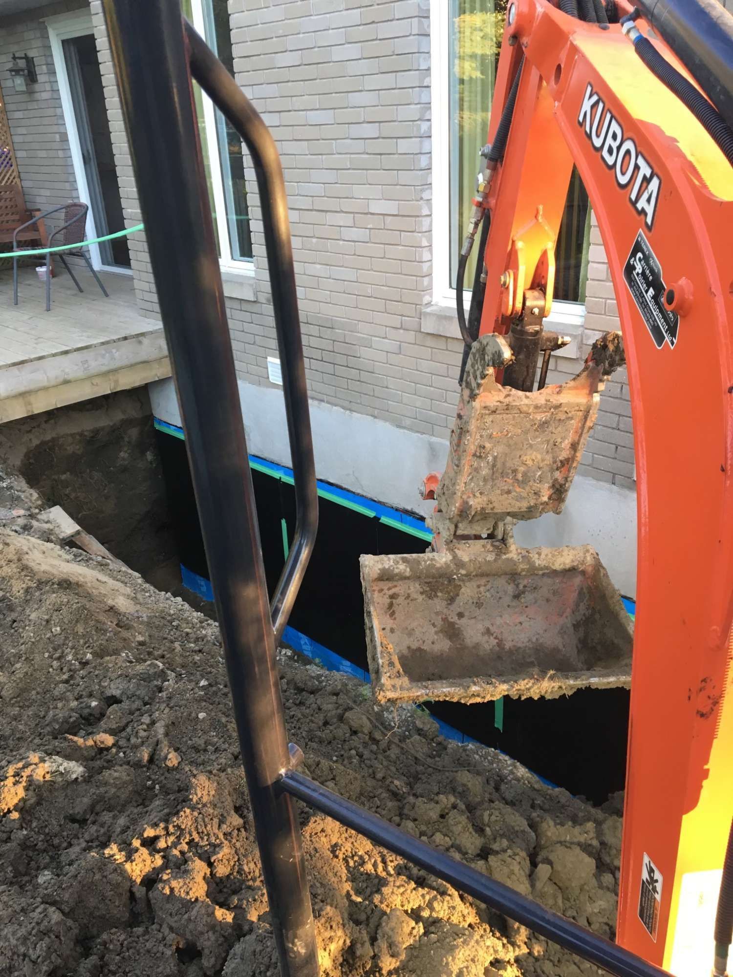 Une excavatrice Kubota creuse un trou dans le sol.