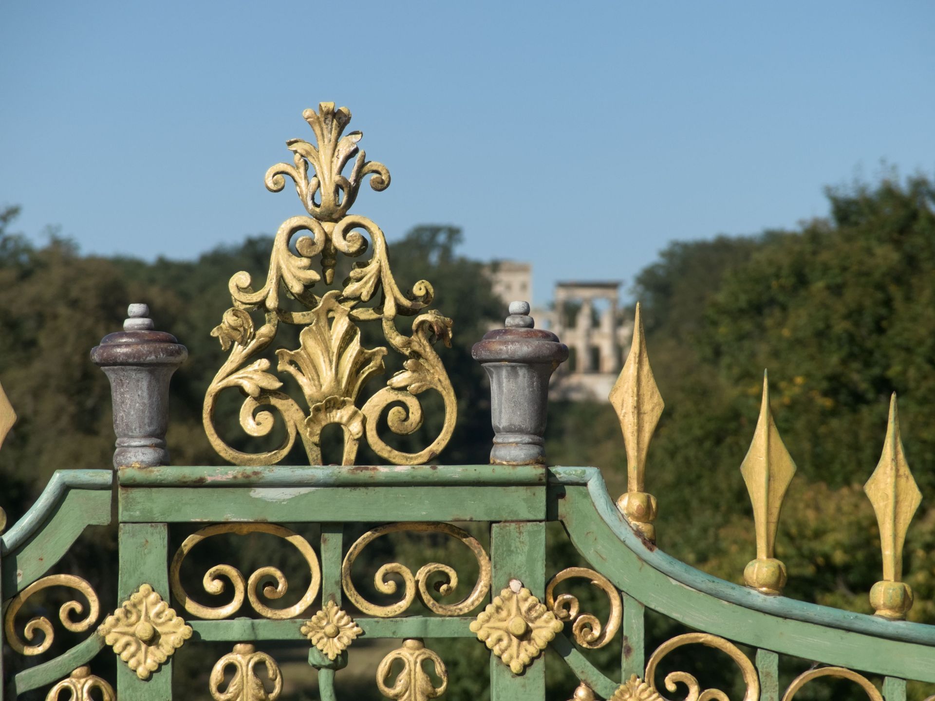 Ornate wrought iron driveway gate with decorative metalwork