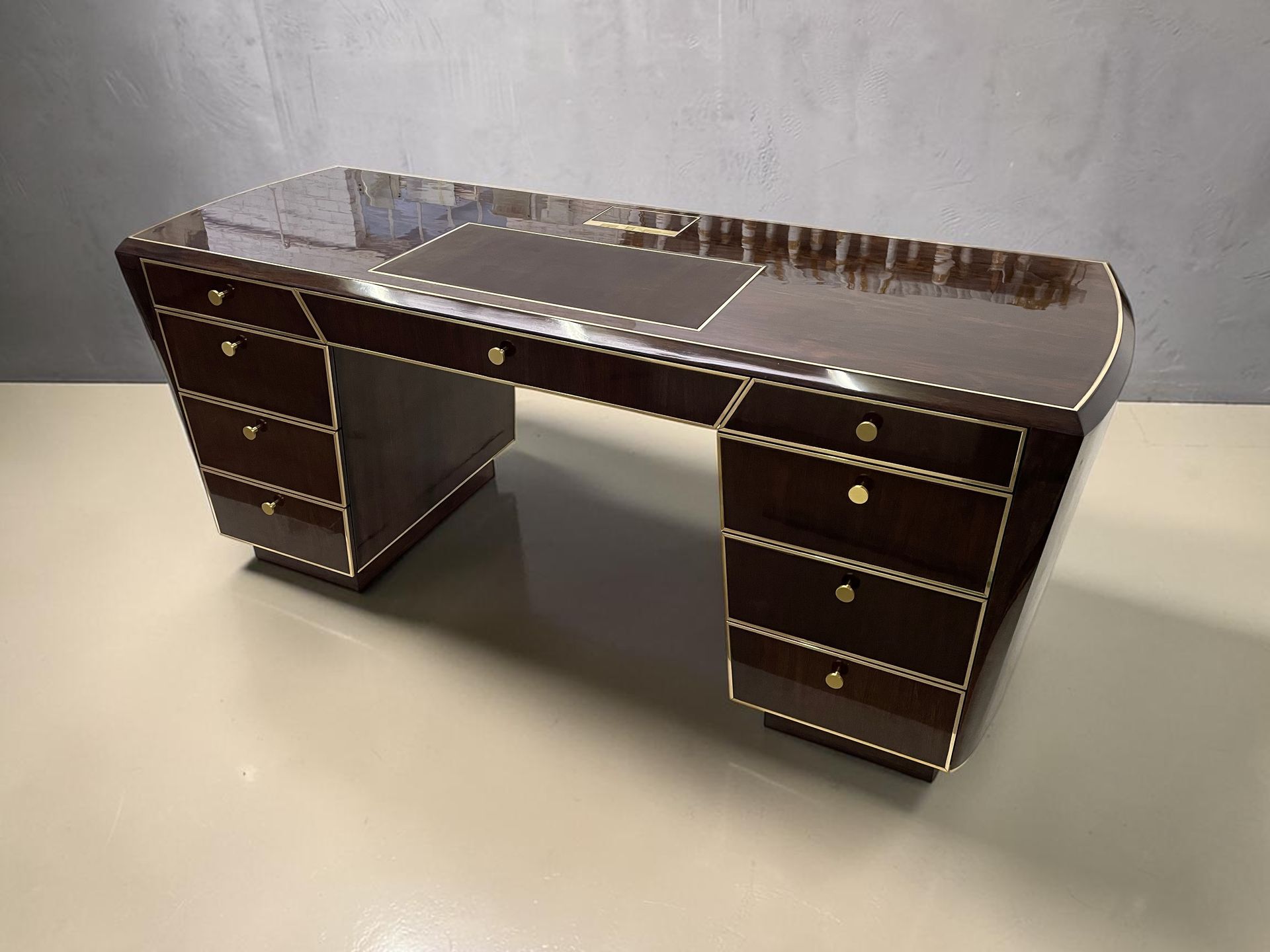 Dark wood executive desk with glossy top, three drawers on each side, shown against a plain wall.