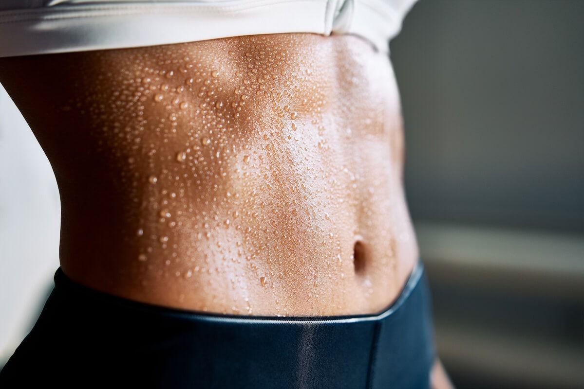 Sweaty torso with defined abdominal muscles.