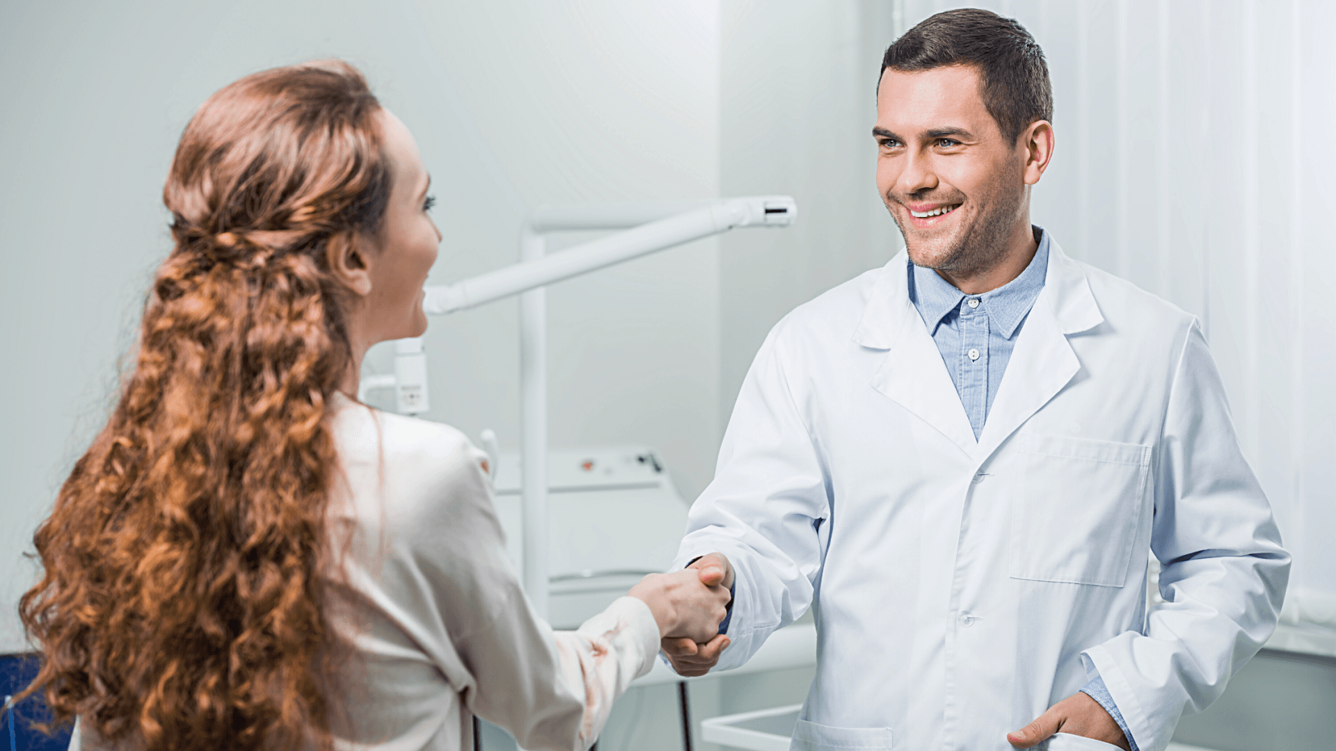 Dentist shaking hands with a business professional