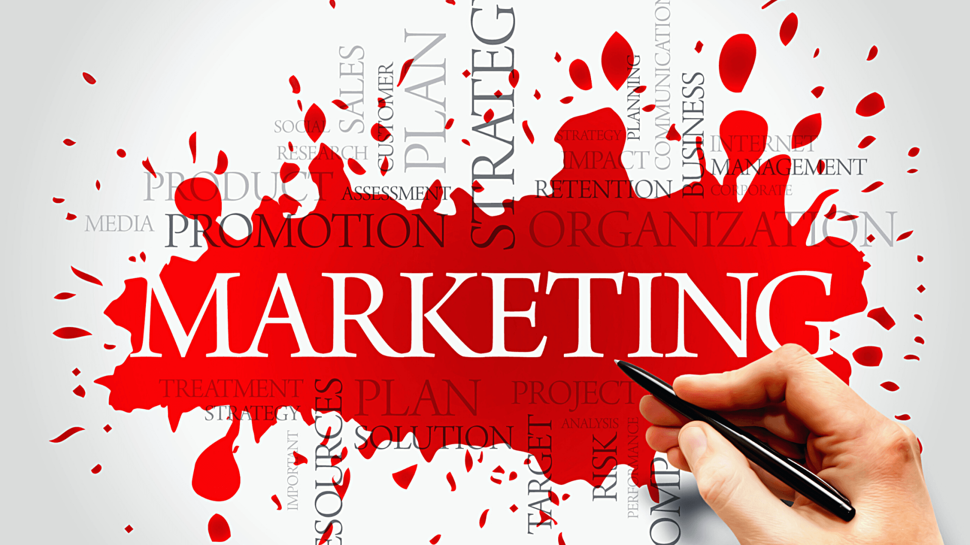 Hand with pen hovering over marketing terms against red splashed background