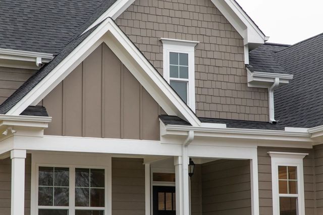 exterior walls with siding and front house door