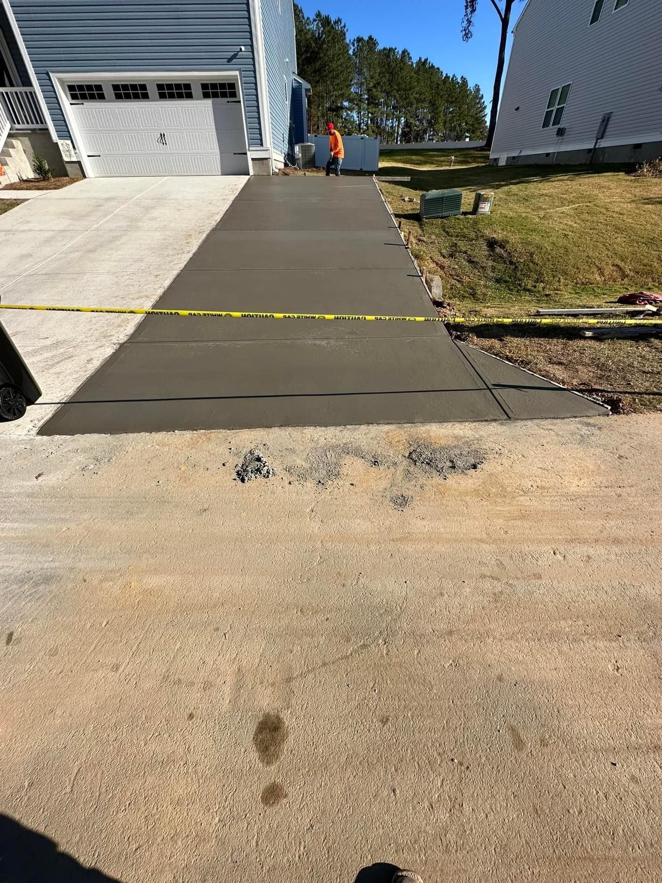 Newly poured concrete driveway extension 