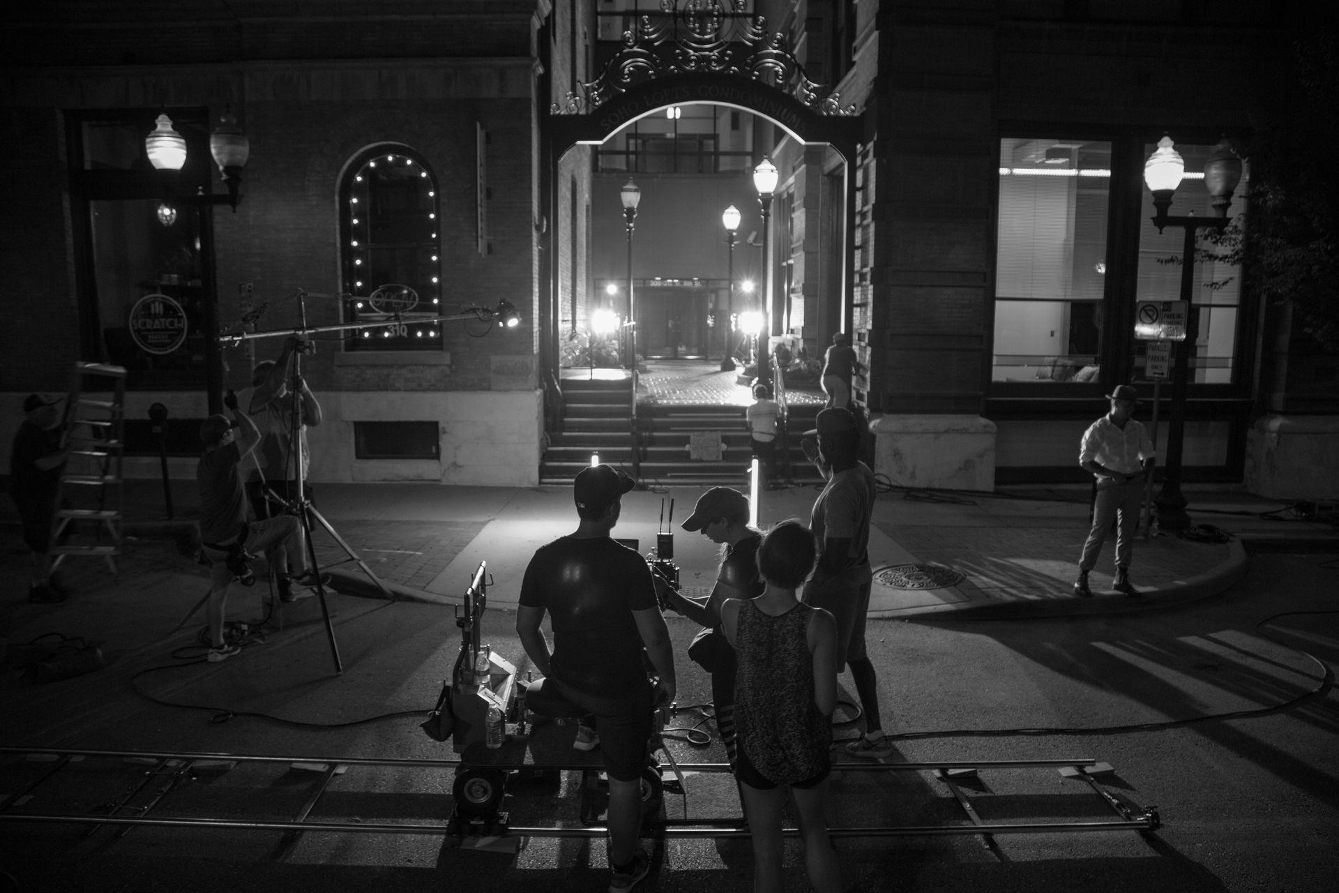 A group of people are standing in front of a building at night.