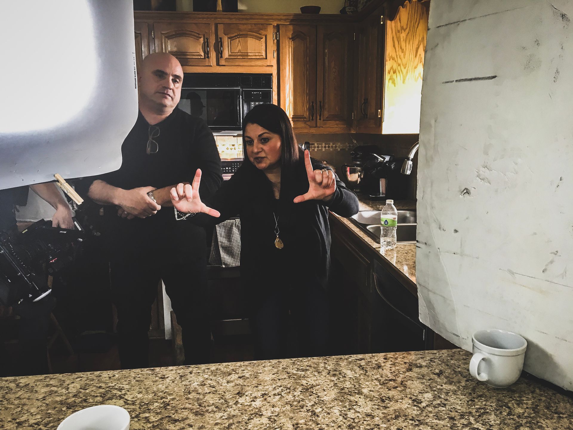 A man and a woman are standing in a kitchen.