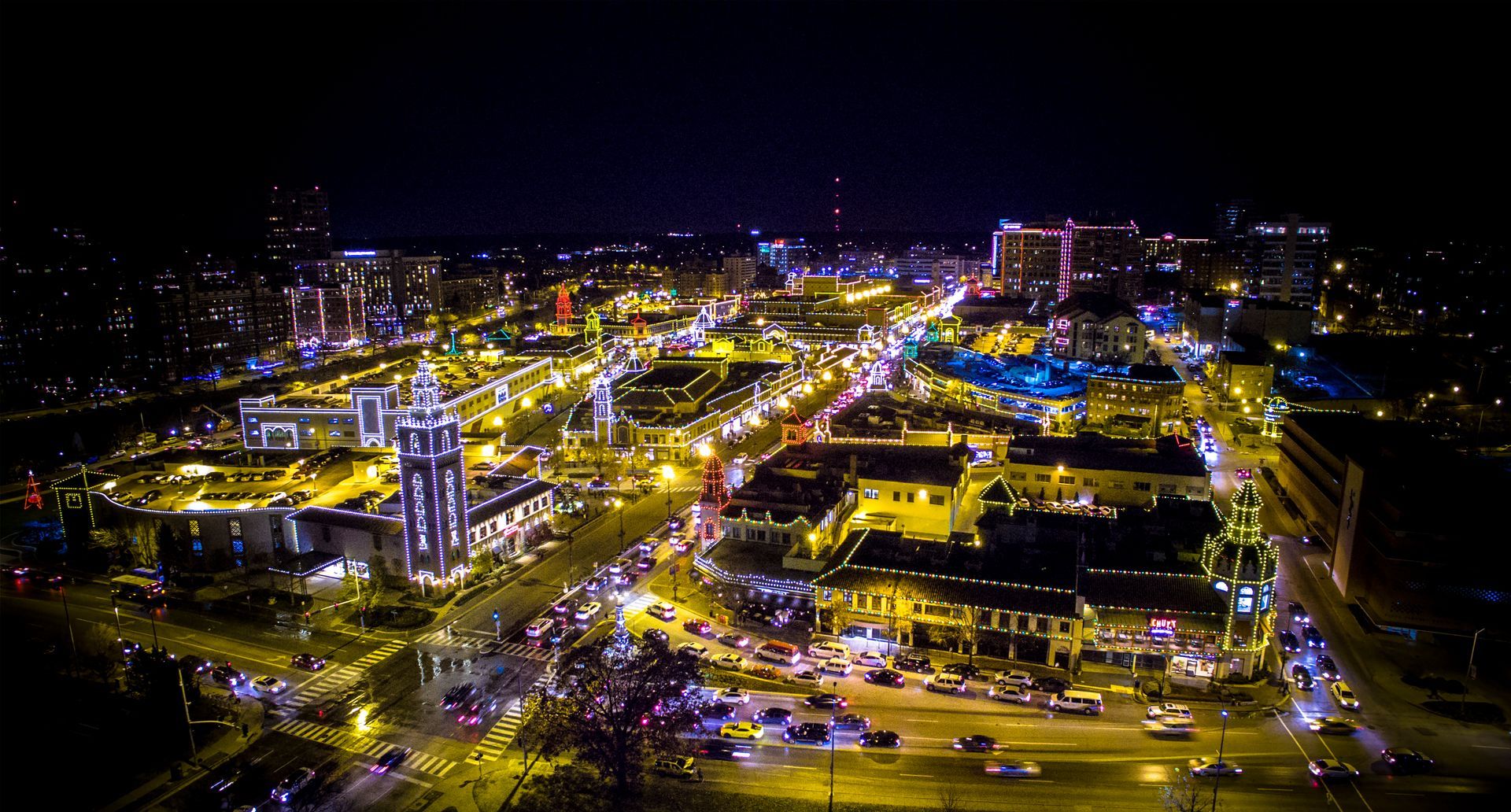 An aerial view of a city at night with lots of lights.