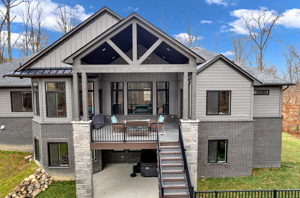A blue house with brown garage doors