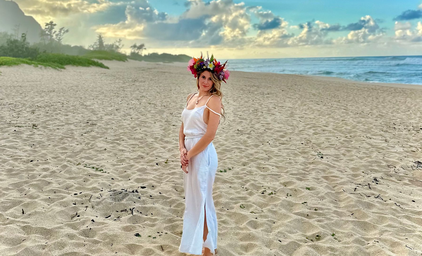 Dr. Stephanie wearing traditional Lei Po'o on the beach