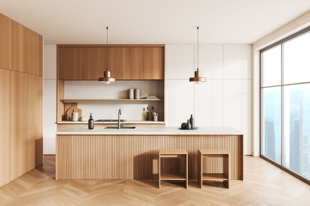 Minimalist wood kitchen with island, bar stools, and large window overlooking a city view