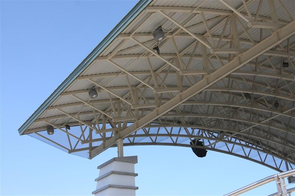 A large metal structure with a blue sky in the background