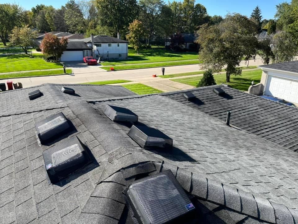 The roof of a house with a lot of skylights on it.