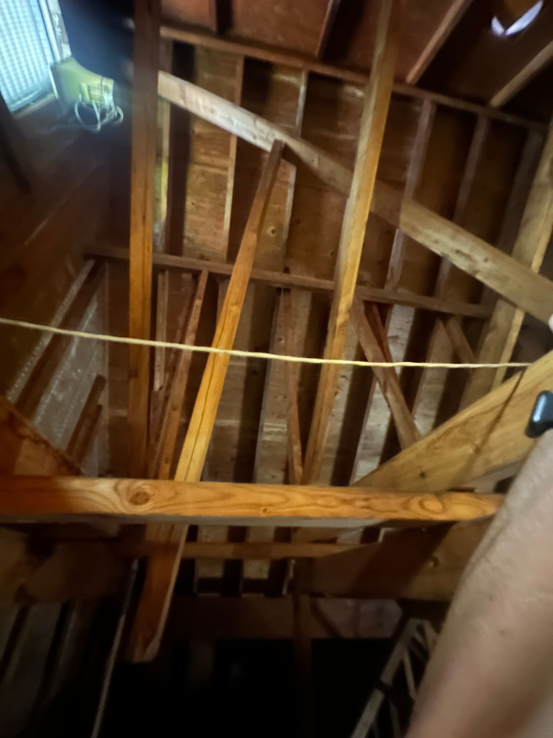 Looking up at the ceiling of a building with wooden beams