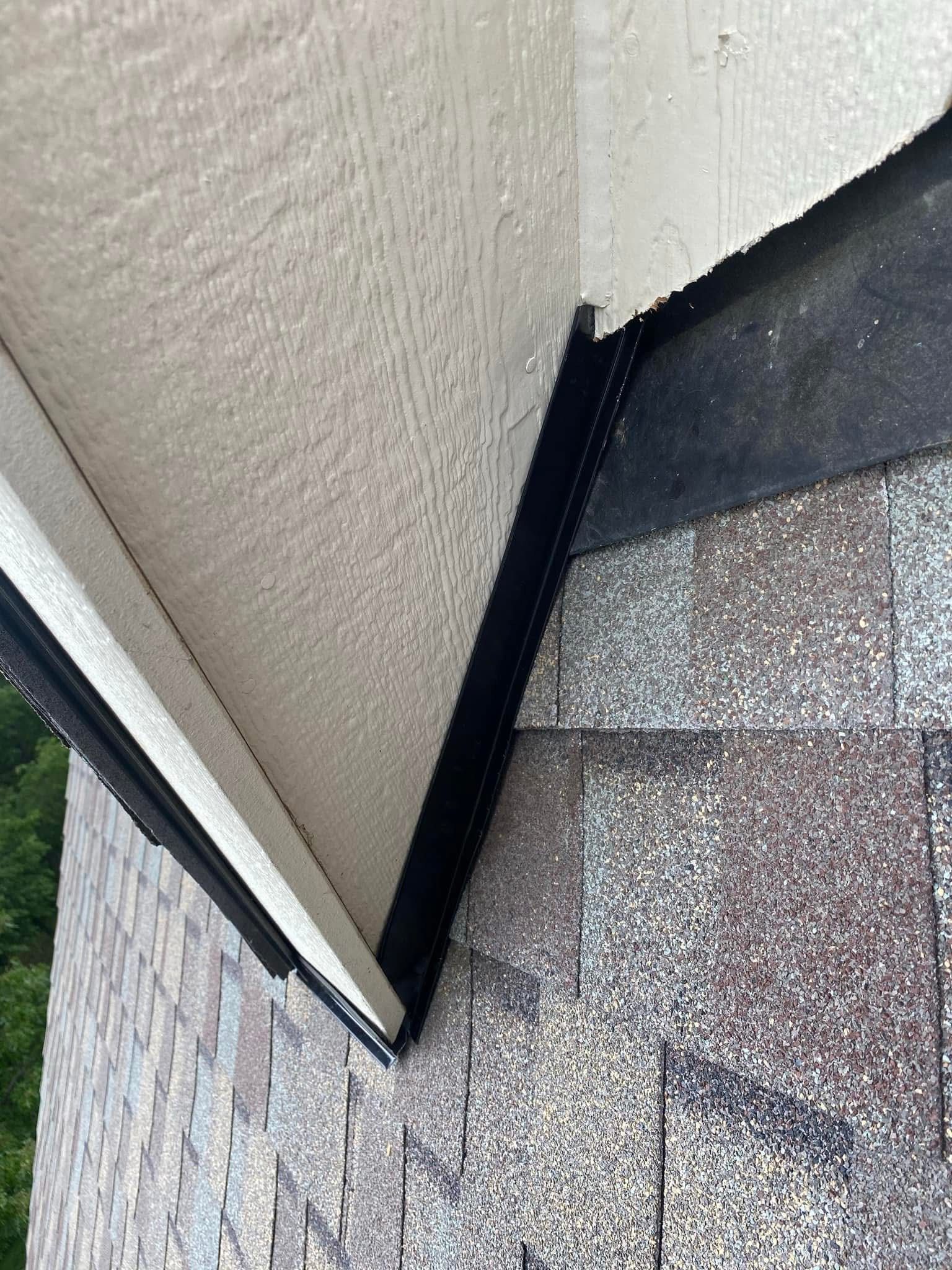 A close up of the roof of a house with shingles on it.