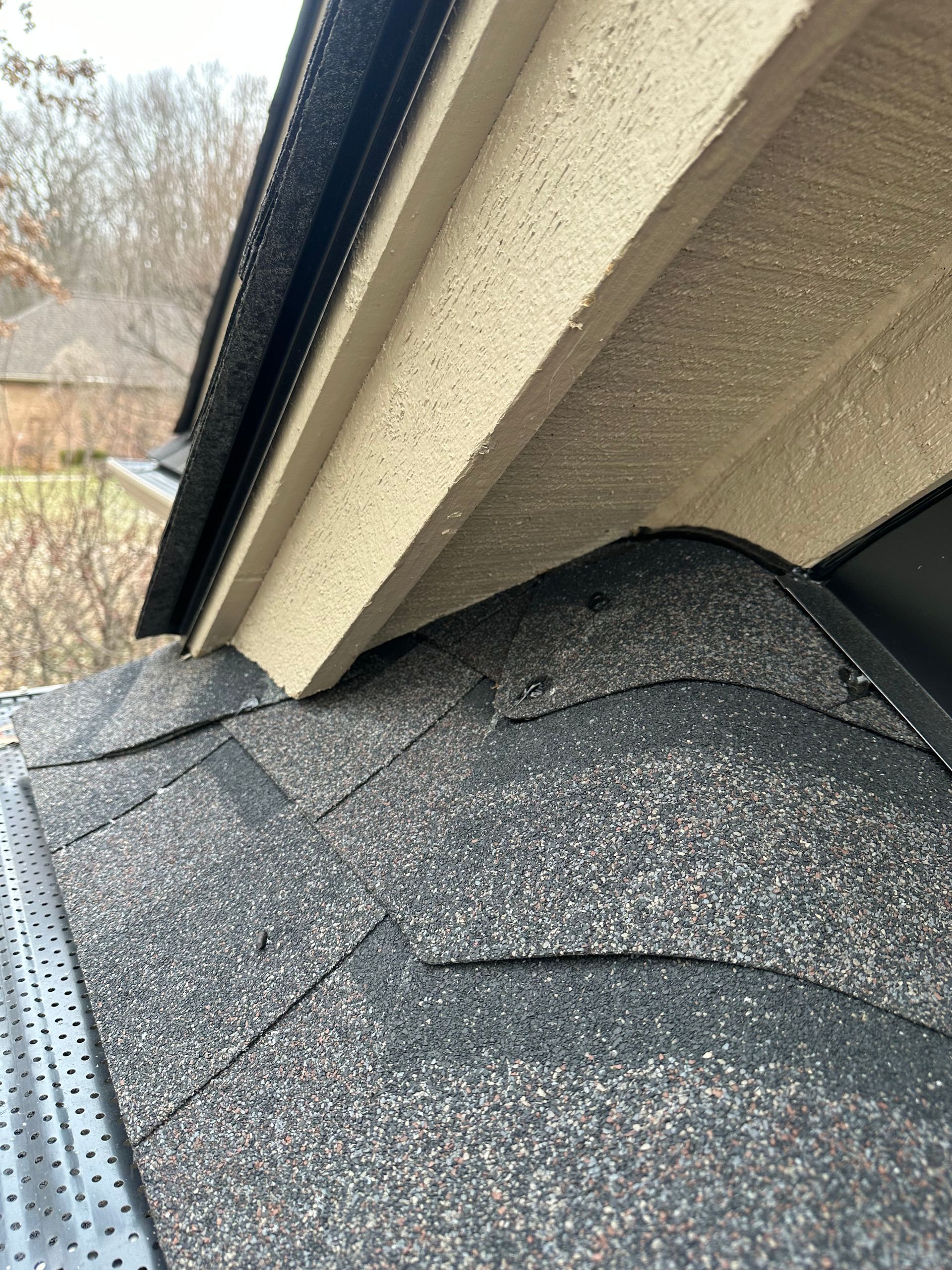 A close up of a roof with a gutter on it.