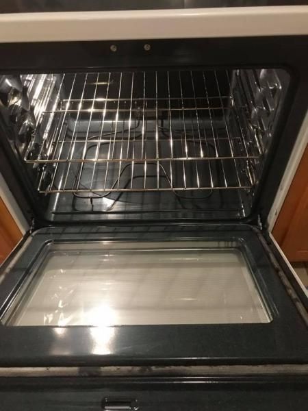 Open oven with empty rack and glass baking dish inside