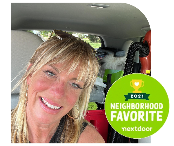Smiling woman in car with 2021 Neighborhood Favorite Nextdoor badge