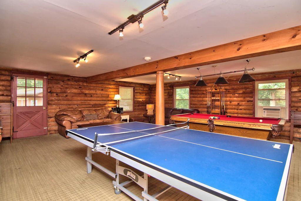 There is a ping pong table in the middle of the room.