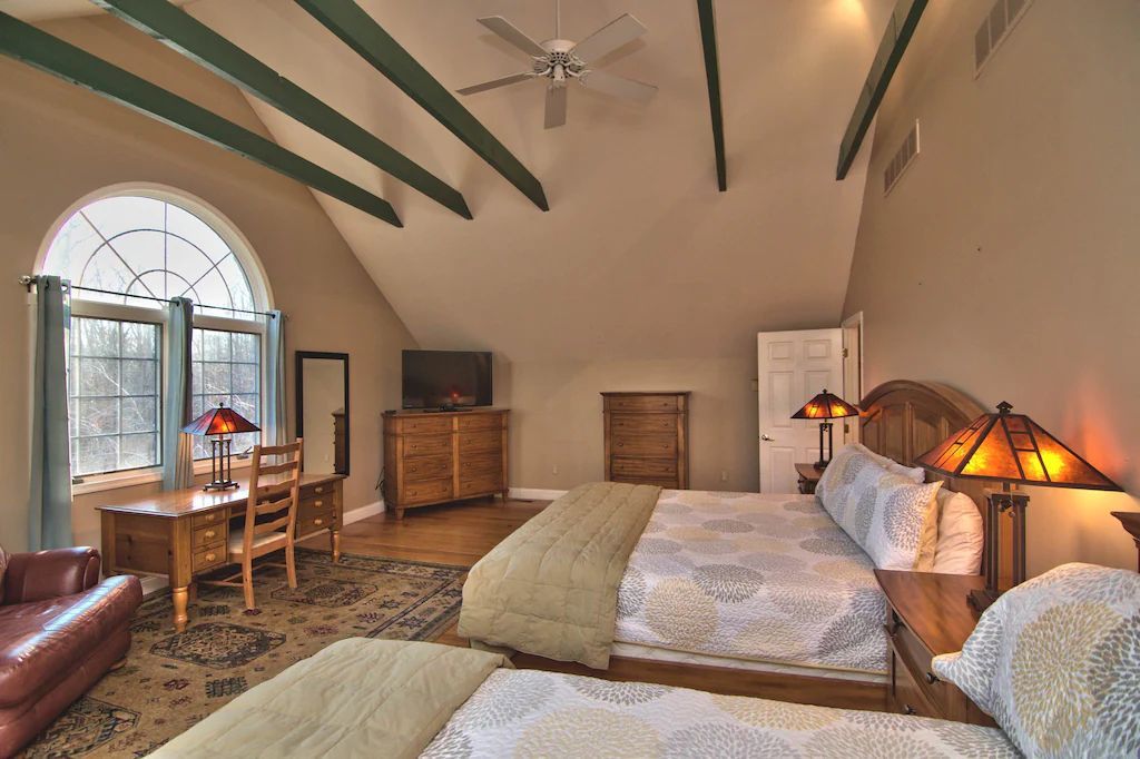 A hotel room with two beds and a desk
