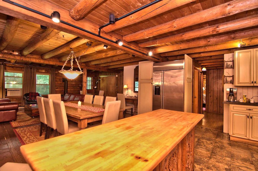 There is a large wooden table in the middle of the room.