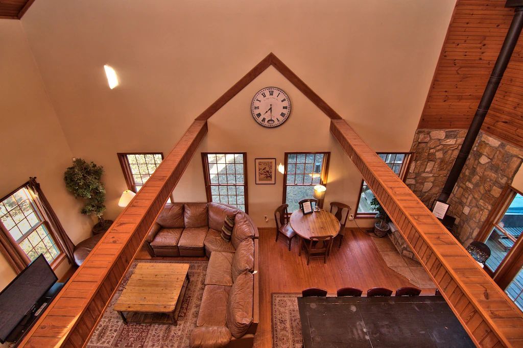 An aerial view of a living room with a clock on the ceiling.