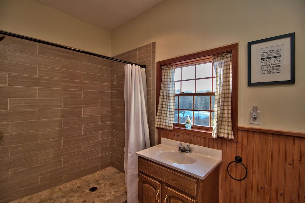 A bathroom with a sink and a walk in shower