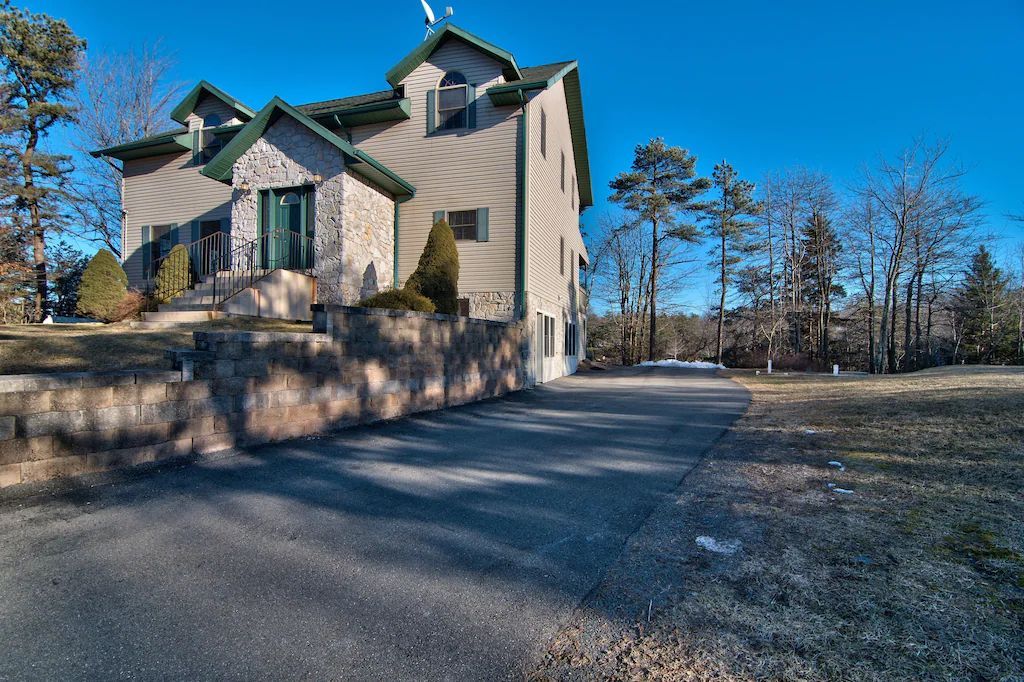 A large house with a driveway leading to it