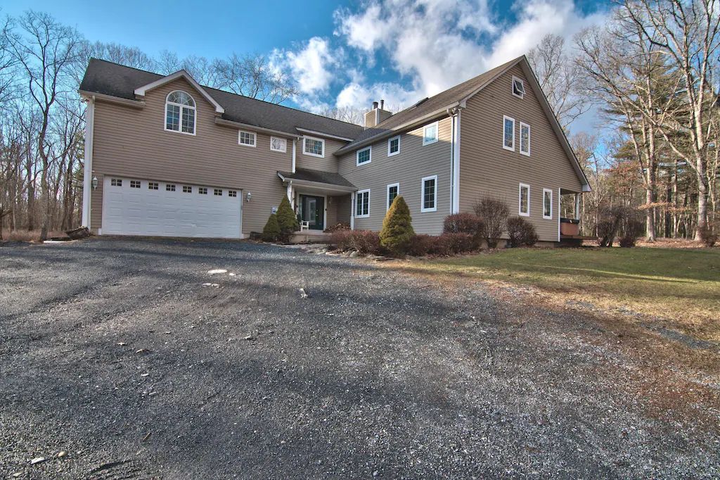 A large house with a driveway in front of it