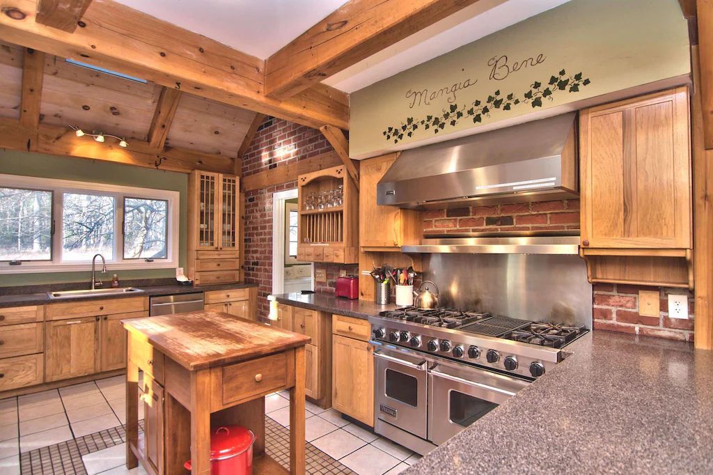 A kitchen with stainless steel appliances and wooden cabinets