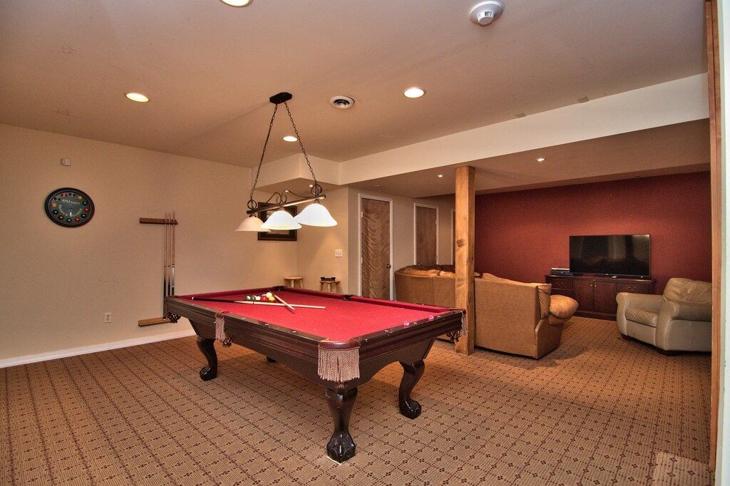 There is a pool table in the middle of the room.