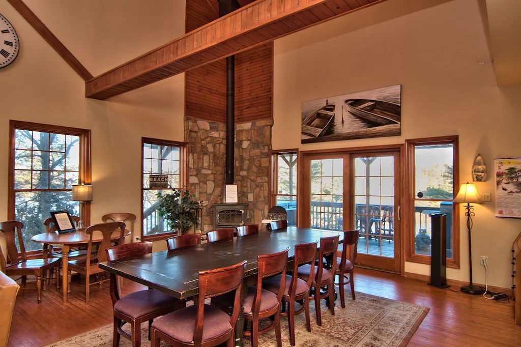 A large room with a table and chairs and a clock on the wall