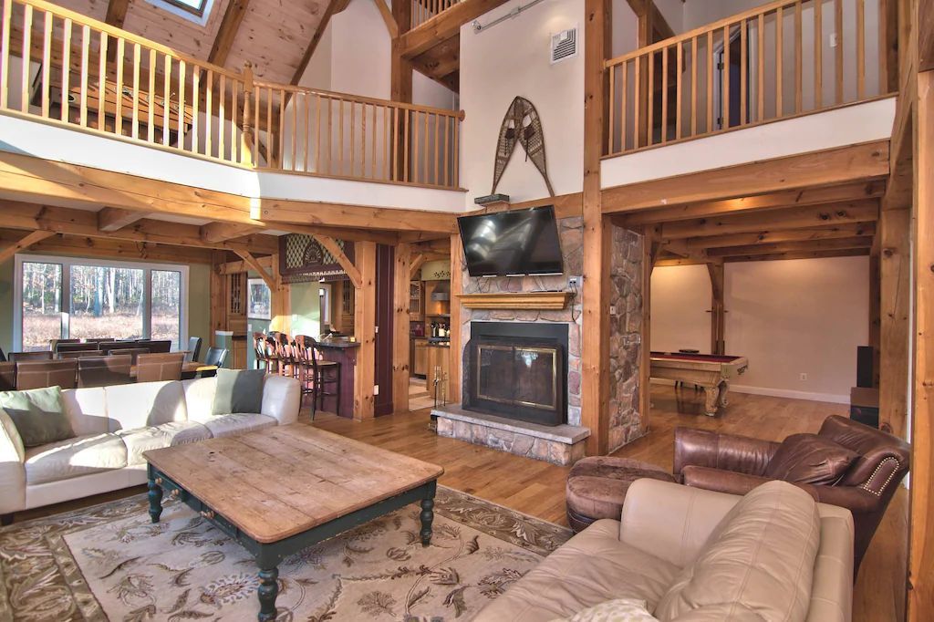 There is a fireplace in the middle of the living room.