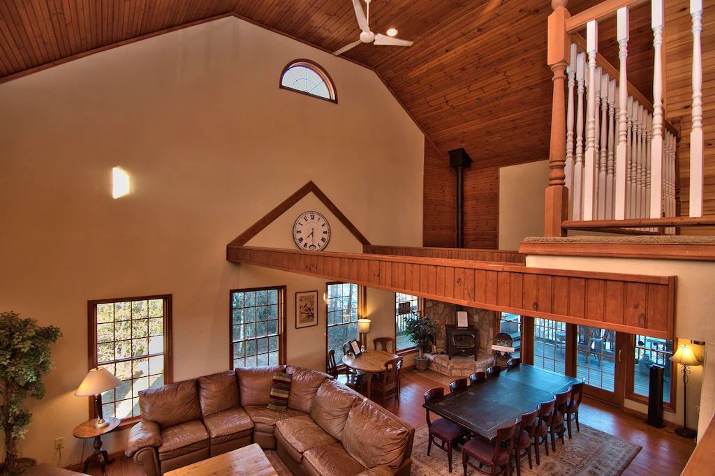 A living room with a couch and a clock on the wall