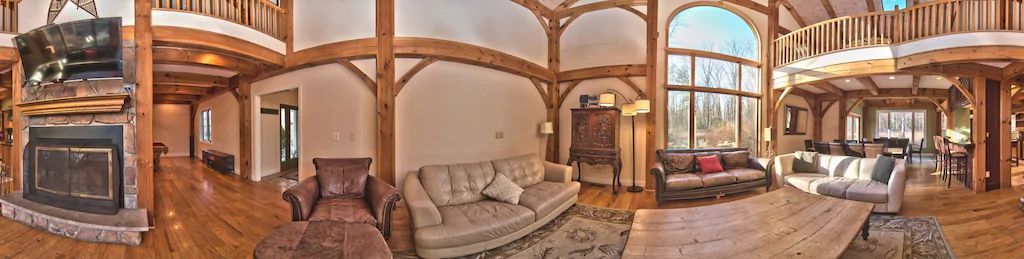 A panoramic view of a living room in a large house.