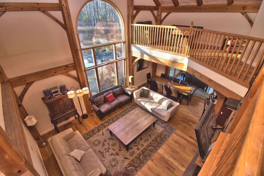 An aerial view of a living room filled with furniture and a balcony.