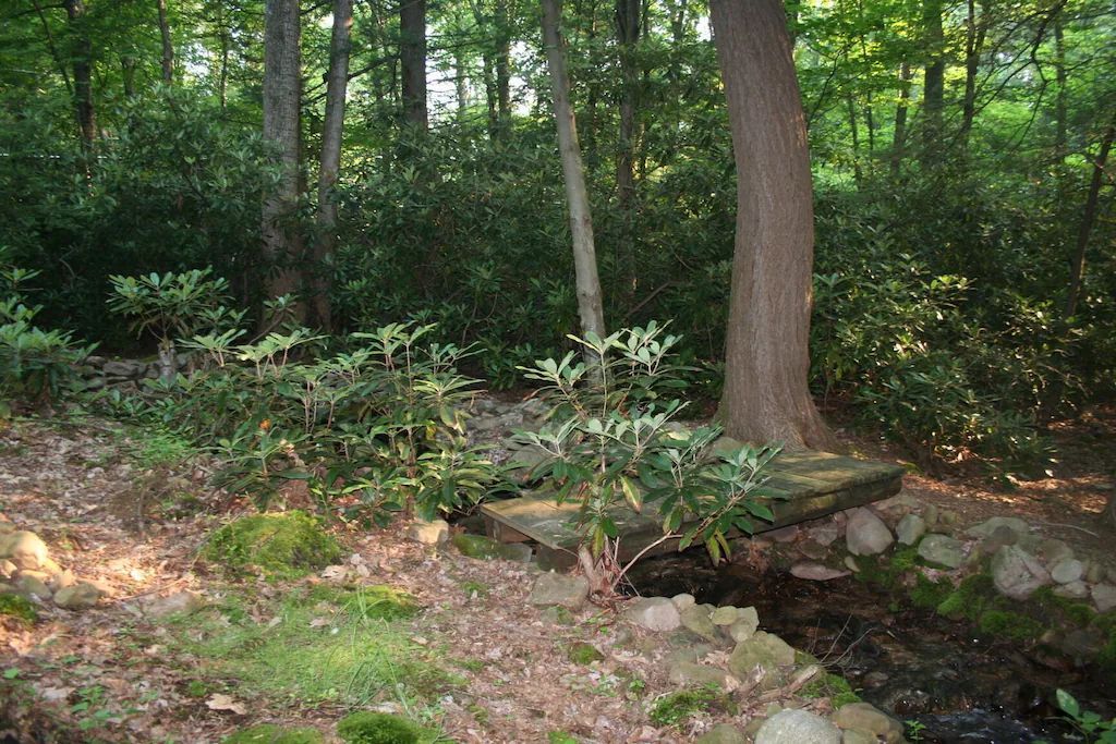 A stone bridge over a stream in the woods