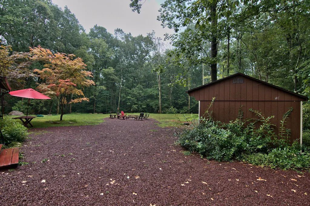 A shed with a red umbrella in front of it