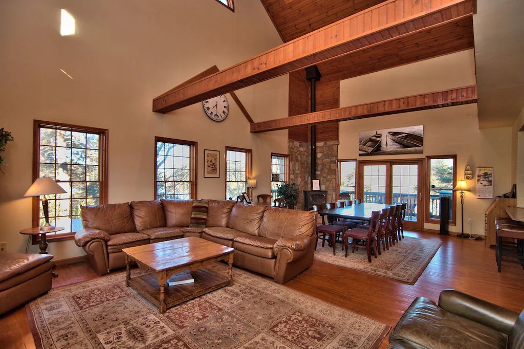 A living room filled with furniture and a clock on the ceiling