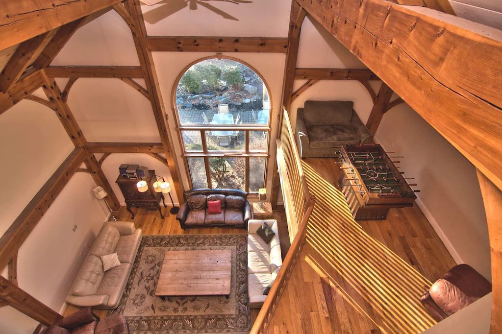 An aerial view of a living room with wooden beams