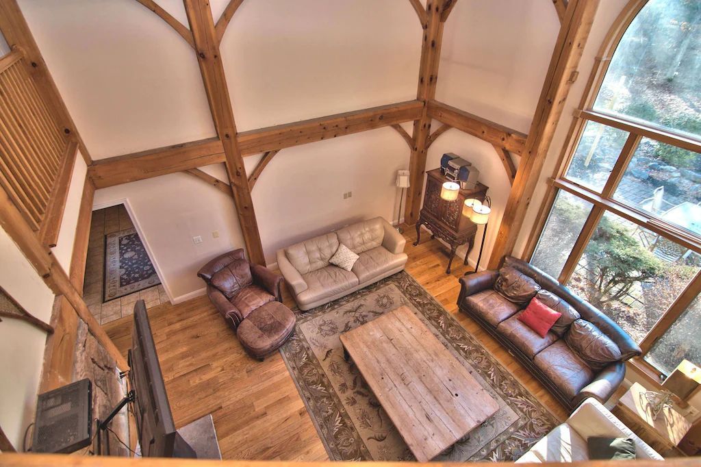 An aerial view of a living room filled with furniture and a fireplace.