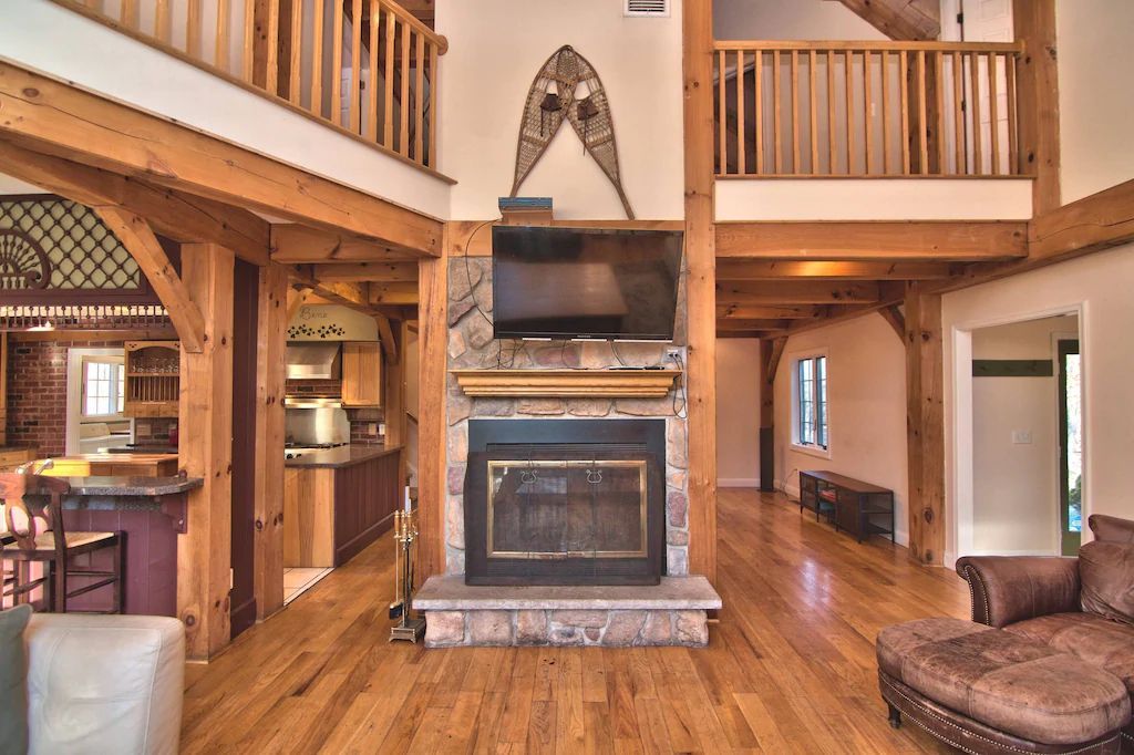 A living room with a fireplace and a flat screen tv.